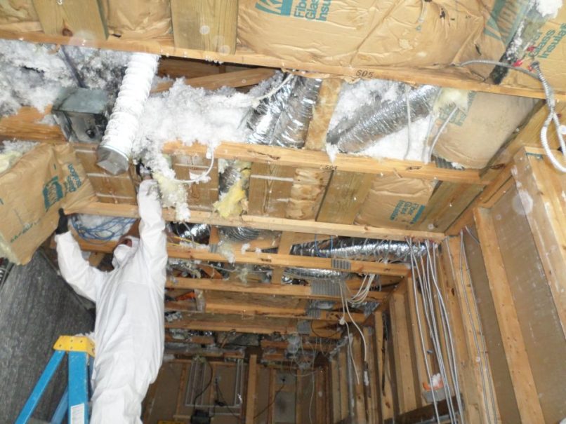 insulation removal in soot covered room before