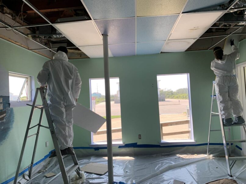 workers suited up for mold conditions