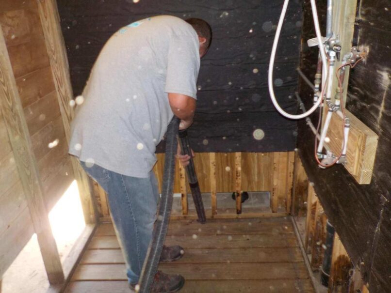 vacuuming debris from wall cavities before rebuilding