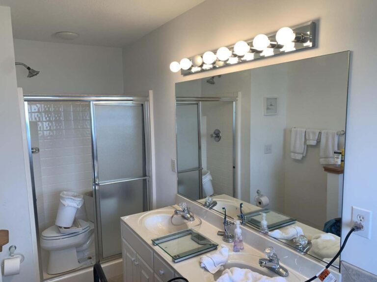 BEFORE with tub/shower at one end of narrow bathroom, jacuzzi at the other end