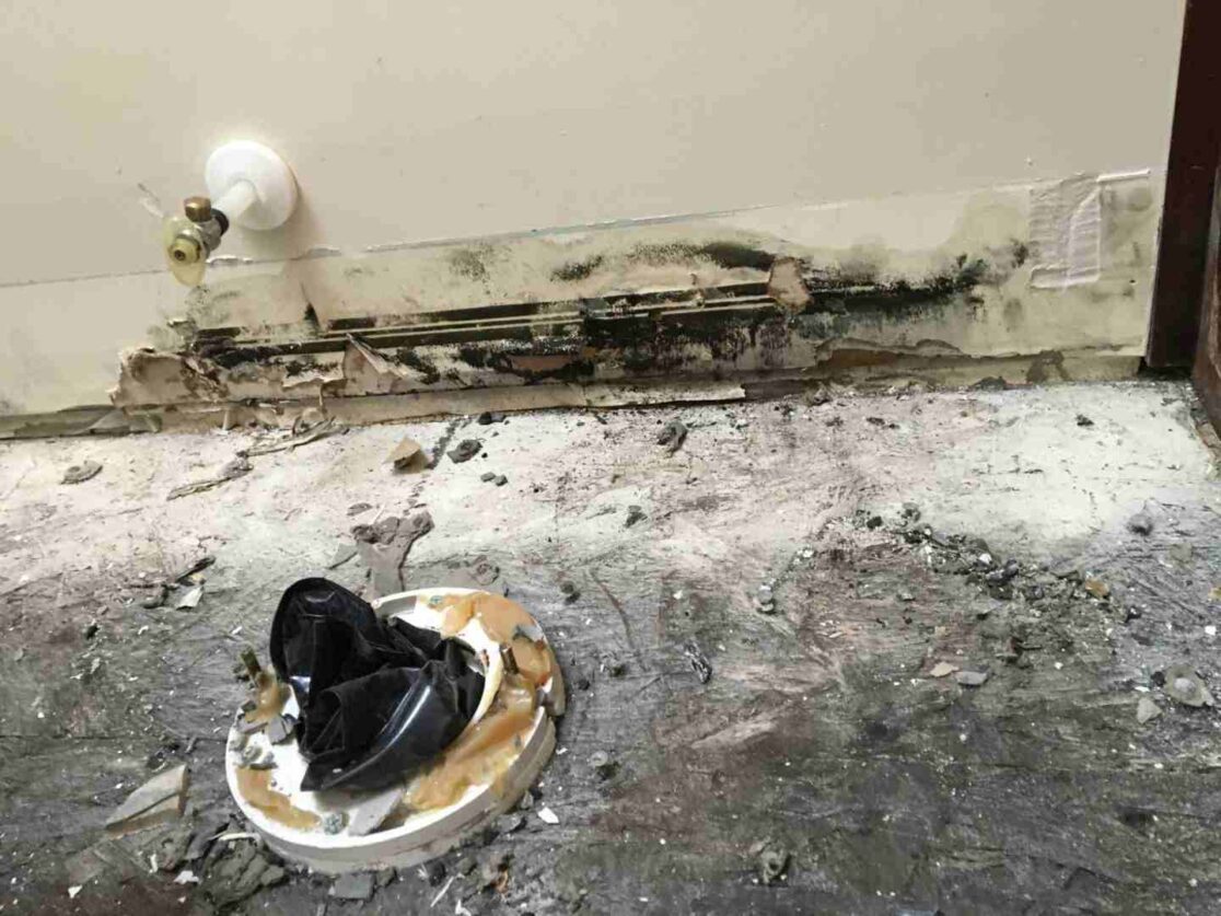 condition of floor and wall behind the causation bathroom toilet