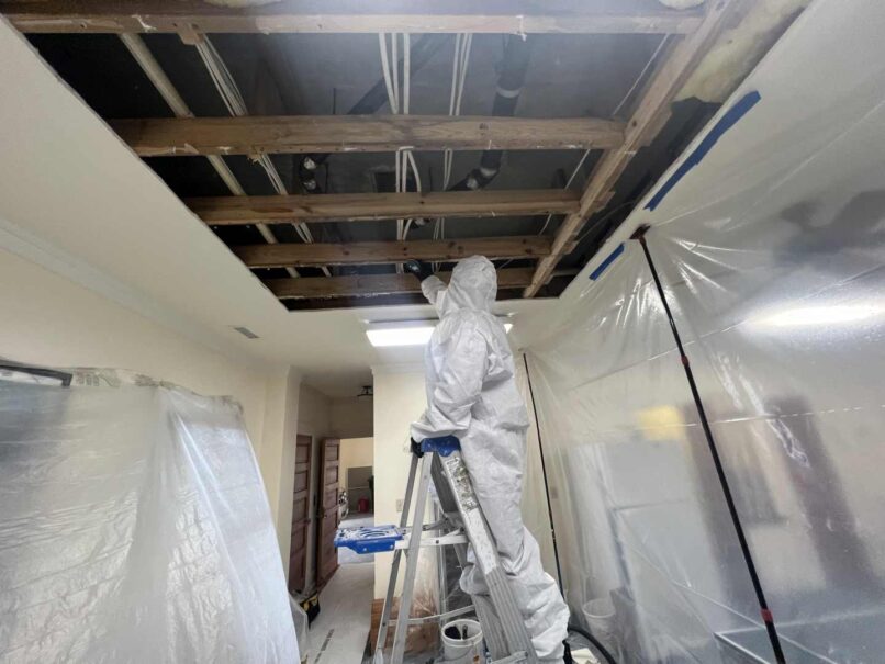 technician cleaning the framing